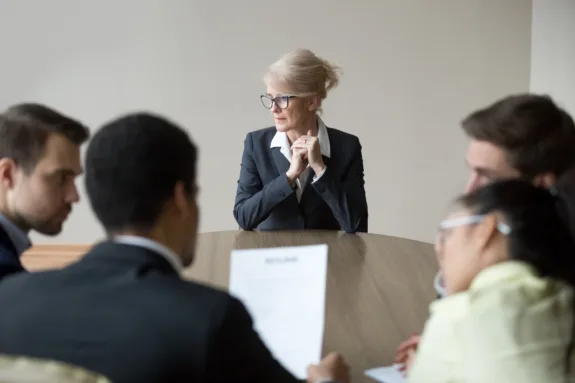 Middle aged stressed woman sitting at the desk in office