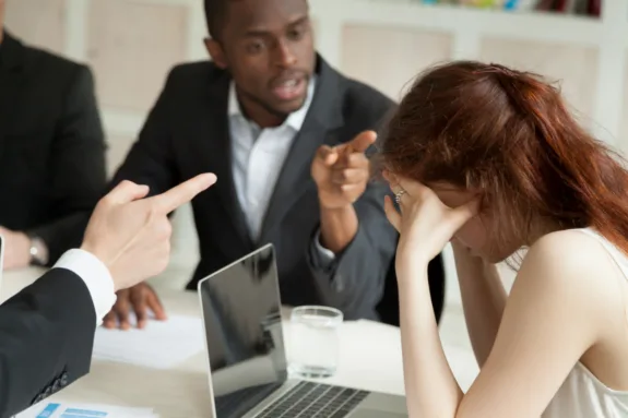 Male colleagues bullying and blaming female associate